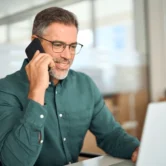 middle-aged-businessman-making-call-600nw-2362307143