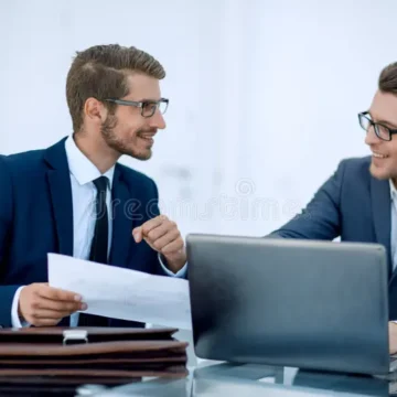 close-up-two-business-men-discussing-business-document-business-concept-close-up-two-business-men-discussing-business-document-125328840
